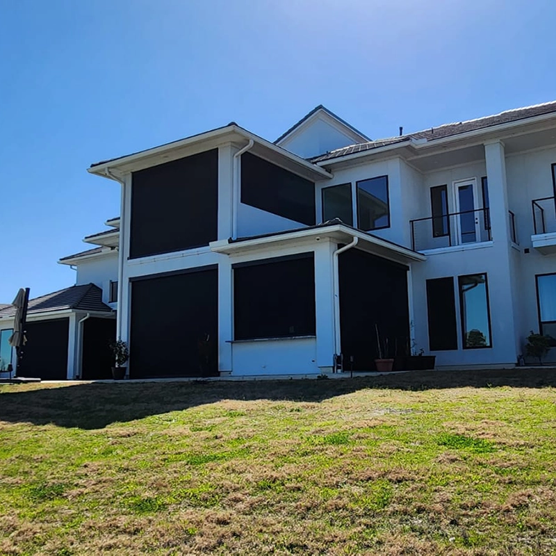 Whole-house ZIP screen system installed on windows, patio, and outdoor living areas for wind and sun protection